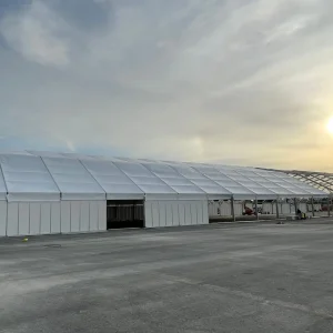 A,Huge,Tent,In,A,Grass,Field,Under,Sunny,Sky