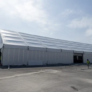 A,Huge,Tent,In,A,Grass,Field,Under,Sunny,Sky
